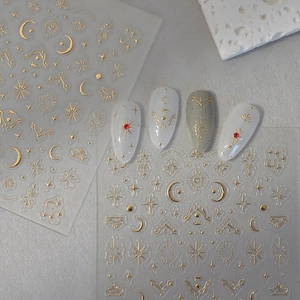 Detail of bohemian gold moon and star nail stickers with metallic foil finish