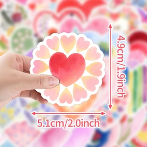 Detailed view showing the 2x2 inch dimensions of the heart doodle sticker held by hand