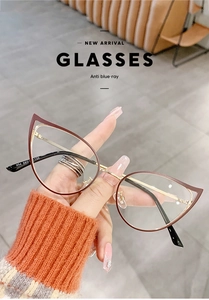 Detailed close-up of wine red cat-eye frame with gold metal temples and anti-blue light lenses