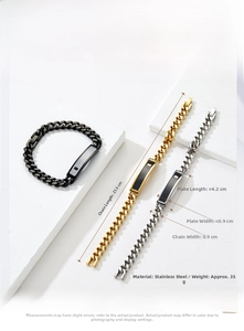 Macro detail of stainless steel Cuban ID bracelet with textured plate in gold and silver