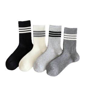 Four pairs of striped mid-calf knit cotton socks in black, white and grey colors