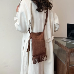 Brown suede tote bag with long fringe detail and adjustable shoulder strap for women