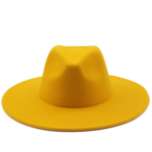 Detail of a bright ginger yellow wool fedora hat with a wide flat brim and structured crown