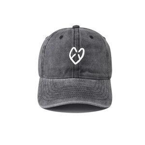 Detail of white heart embroidery on washed gray cotton vintage baseball cap texture