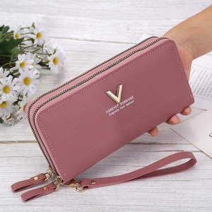 Women's pink long double zipper wallet in lychee leather with wrist strap and V-gold hardware