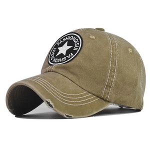 Detailed view of embroidered star patch and distressed washed cotton on baseball cap