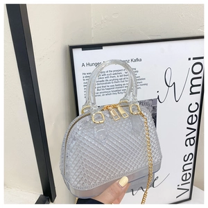 Close-up of PVC shell bag showing diamond quilted texture and gold chain strap