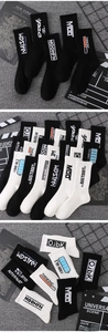Detail view of cotton crew socks with knit letter graphics and industrial street style