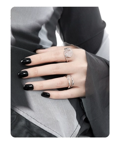 Detailed close-up of a double-layered wavy S925 silver ring and oval crystal ring