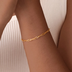 Golden paperclip chain bracelet for women with textured rectangular links on wrist