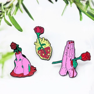 Creative rose enamel pin set with anatomical heart, hands, and body on a clean background
