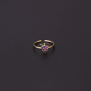 Macro shot of grape-shaped gold ring with purple zircons and green leaf detail