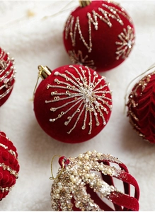 Close-up of 8cm burgundy flocked Christmas balls with sequins and intricate beadwork