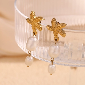 Macro view of 18K gold plated starfish earrings with two hanging white pearls