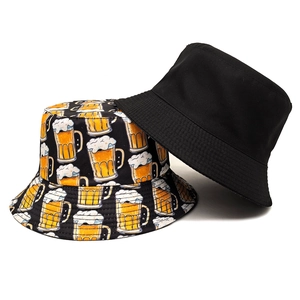 Reversible bucket hat in black with yellow beer mug print for outdoor sun protection