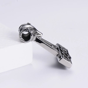 Detail view of silver stainless steel Thor hammer pendant with ram head and Nordic carvings