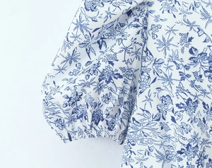 Detailed close-up of blue floral puff sleeves with elastic cuffs on a summer dress