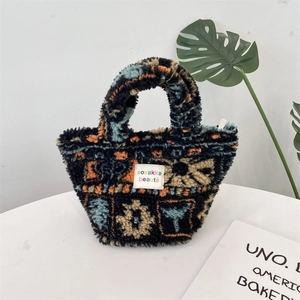 Close-up of plush mini handbag with colorful bohemian patterns and brand logo label