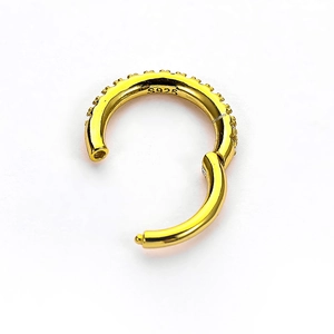 Golden S925 sterling silver nose ring featuring small inlaid zircon gemstones