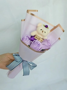Detail of soap rose bouquet with a cute white plush bear holding a Happy Day wooden sign