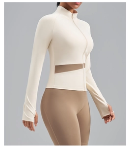 Detail of cream yoga jacket with thumb holes and brown side patchwork panels