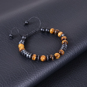 Close-up of natural tiger eye and matte stone beads on adjustable braided cord