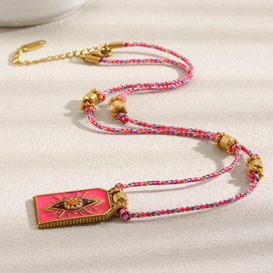 Detail of pink hand-woven cord necklace with 18K gold plated evil eye pendant