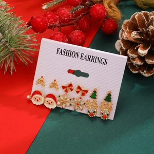 Detail view of 6-pair Christmas stud earrings set with Santa, reindeer and tree motifs