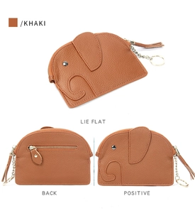 Detailed view of khaki leather elephant coin purse with lychee texture and gold keychain