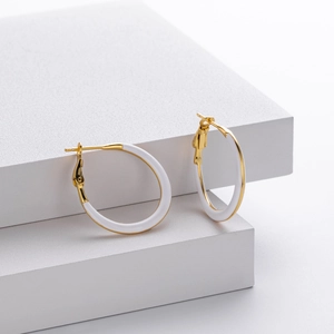 Elegant 925 sterling silver hoop earrings with gold finish and white enamel inlay