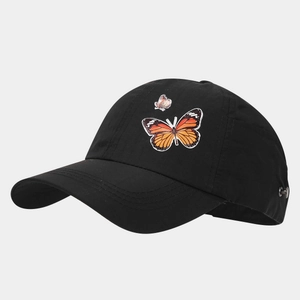 Detail of black baseball cap featuring butterfly embroidery and adjustable metal buckle