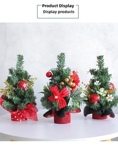Detail of mini Christmas trees with red berries and bows for tabletop decoration