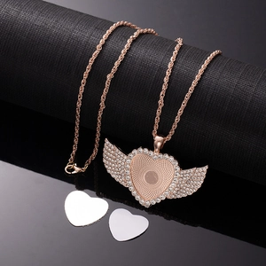 Detailed view of rose gold angel wing heart necklace with sublimation inserts and rhinestones