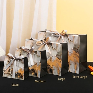 Gray marble gift bags with gold foil accents and ribbon bows in four assorted sizes