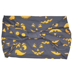 Dark grey Halloween headband with yellow pumpkin face pattern and center knot tie