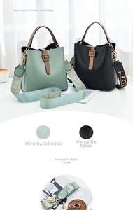 Detail view of stylish bucket bag with wide geometric pattern strap and top handle