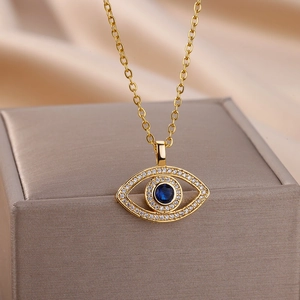 Detailed view of evil eye necklace with blue zircon and white crystals on a jewelry box
