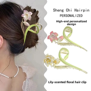 Detailed view of elegant lily flower hair claws with pearls and vibrant painted petals