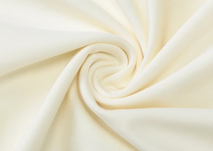 Detailed macro view of soft cream ribbed knit fabric texture with elegant pleated folds