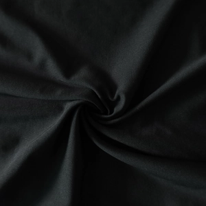 Close-up of black textured fabric with elegant ruching and subtle sheen detail