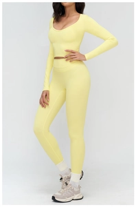 Detailed view of high-waist yoga set in yellow featuring crop top and sleek leggings