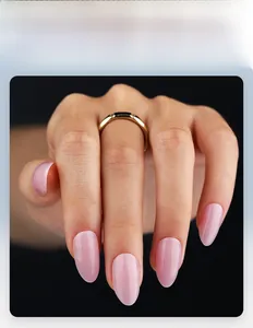 Detailed view of pink translucent almond press-on nails with golden ring accessory