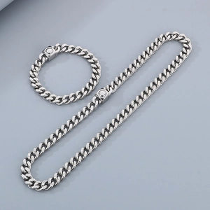 Detailed view of silver Cuban link necklace and bracelet set with square clasp closure
