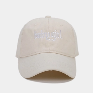 Detailed view of 3D gothic babygirl embroidery on beige cotton baseball cap