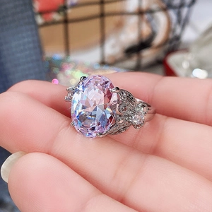 Detailed close-up of oval lavender zircon ring with butterfly accents on silver band