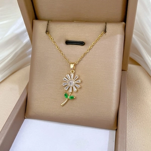 Detailed macro view of a gold sunflower necklace with crystals in a velvet jewelry box