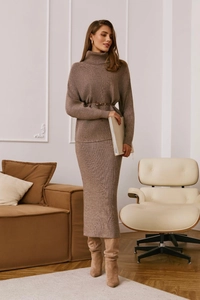 Brown knit sweater and matching midi skirt set with a belt shown in a modern interior