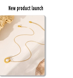 Detailed shot of a 18k gold plated titanium necklace with heart faux pearl pendant