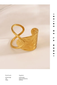 Detailed view of wide golden open ring with hammered texture and hollow geometric lines