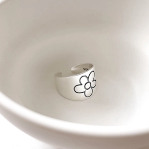 Macro view of 925 sterling silver ring with black floral pattern and matte finish